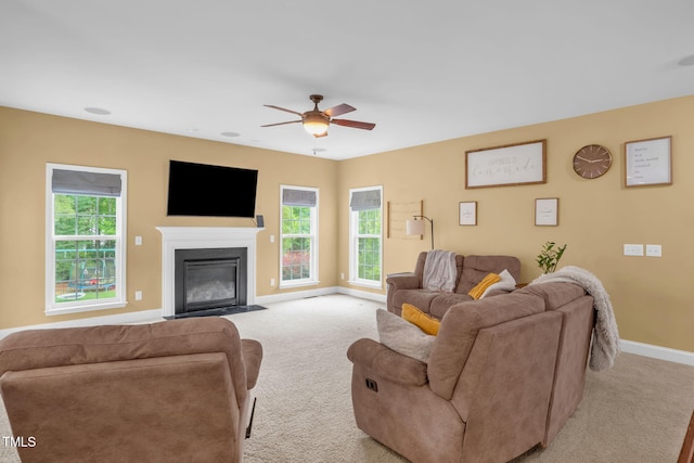 1428 White Opal Dr, Knightdale, NC 27545 - living area featuring light colored carpet, baseboards, a ceiling fan, and a fireplace with flush hearth