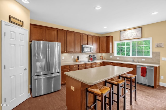 1428 White Opal Dr, Knightdale, NC 27545 - kitchen featuring stainless steel appliances, wood finished floors, light countertops, a sink, and recessed lighting