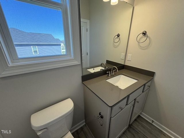 140 Brookhaven Dr, Spring Hope, NC 27882 - half bathroom featuring vanity, wood finished floors, toilet, and baseboards