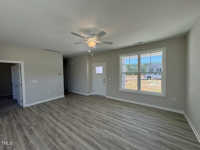 140 Brookhaven Dr, Spring Hope, NC 27882 - unfurnished living room featuring wood finished floors, a ceiling fan, and baseboards