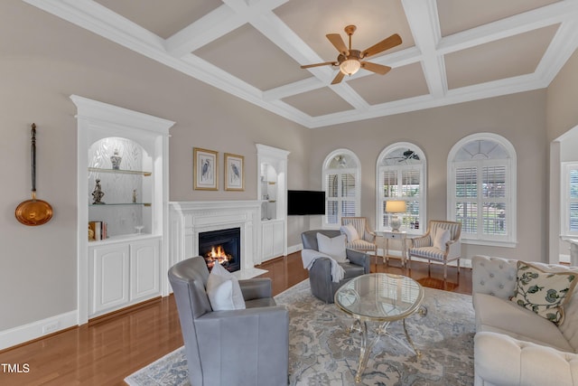 7800 Twin Pines Way, Fuquay Varina, NC 27526 - living room featuring a ceiling fan, a fireplace with flush hearth, coffered ceiling, wood finished floors, and beamed ceiling