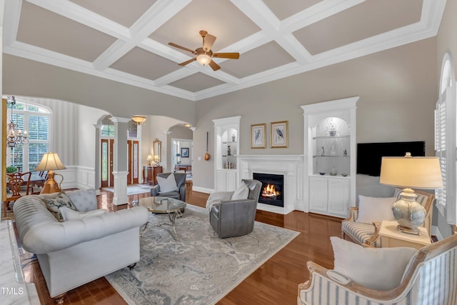 7800 Twin Pines Way, Fuquay Varina, NC 27526 - living area featuring decorative columns, coffered ceiling, a fireplace with flush hearth, ceiling fan, and wood finished floors