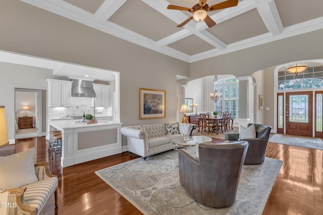 7800 Twin Pines Way, Fuquay Varina, NC 27526 - living room with a chandelier, a ceiling fan, coffered ceiling, arched walkways, and crown molding