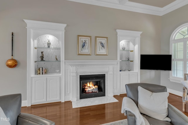 7800 Twin Pines Way, Fuquay Varina, NC 27526 - living area featuring a fireplace, wood finished floors, crown molding, built in shelves, and baseboards