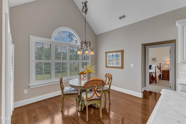 7800 Twin Pines Way, Fuquay Varina, NC 27526 - dining area featuring high vaulted ceiling, wood finished floors, baseboards, and a chandelier