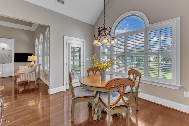 7800 Twin Pines Way, Fuquay Varina, NC 27526 - dining area with wood finished floors, a chandelier, baseboards, and lofted ceiling