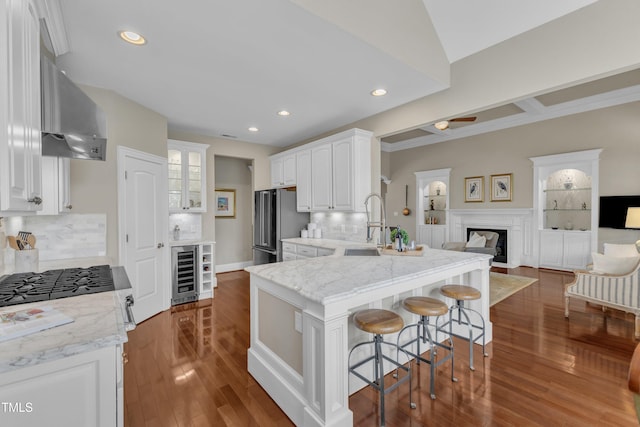 7800 Twin Pines Way, Fuquay Varina, NC 27526 - kitchen featuring freestanding refrigerator, beverage cooler, a breakfast bar, white cabinets, and wall chimney exhaust hood