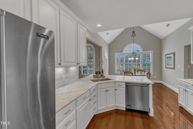 7800 Twin Pines Way, Fuquay Varina, NC 27526 - kitchen featuring appliances with stainless steel finishes, a sink, a peninsula, dark wood-type flooring, and white cabinetry