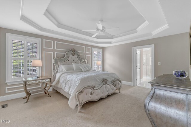 7800 Twin Pines Way, Fuquay Varina, NC 27526 - bedroom featuring a raised ceiling, multiple windows, light colored carpet, baseboards, and ornamental molding