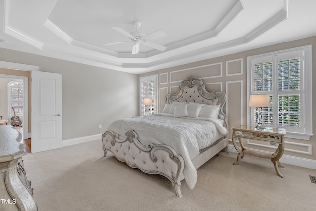 7800 Twin Pines Way, Fuquay Varina, NC 27526 - bedroom featuring a raised ceiling, light carpet, crown molding, ceiling fan, and baseboards