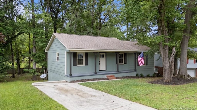 2308 Keith Dr, Raleigh, NC 27610 - view of front facade featuring covered porch, roof with shingles, a front yard, and concrete driveway