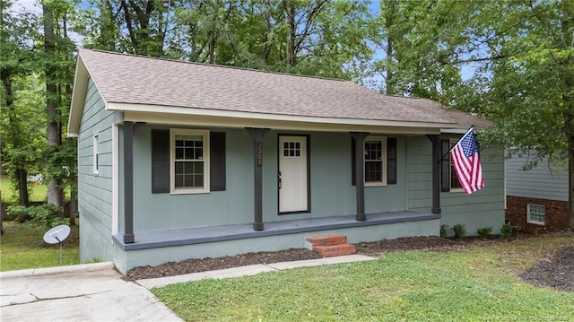 2308 Keith Dr, Raleigh, NC 27610 - view of front of home with covered porch, a shingled roof, and a front yard