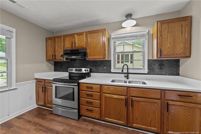 2308 Keith Dr, Raleigh, NC 27610 - kitchen featuring electric stove, a sink, under cabinet range hood, dark wood-type flooring, and brown cabinetry