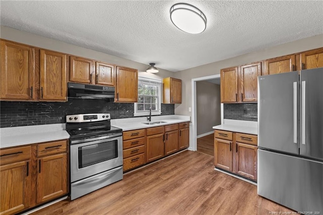 2308 Keith Dr, Raleigh, NC 27610 - kitchen with stainless steel appliances, ventilation hood, a sink, a textured ceiling, and light countertops