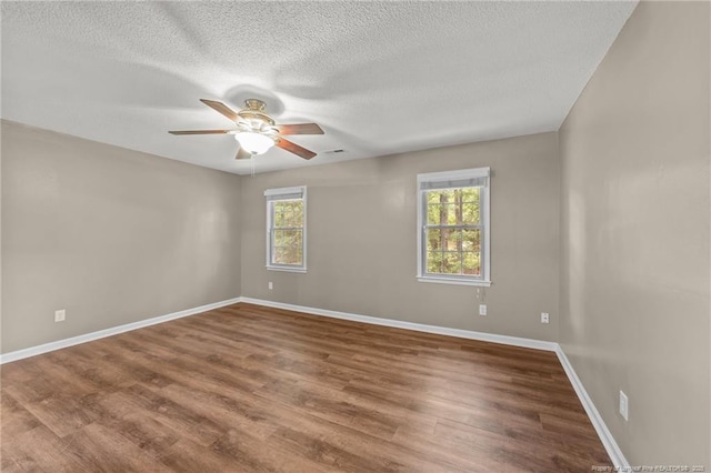2308 Keith Dr, Raleigh, NC 27610 - spare room with a ceiling fan, baseboards, wood finished floors, and a textured ceiling
