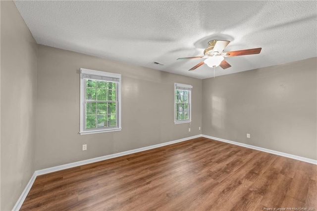 2308 Keith Dr, Raleigh, NC 27610 - empty room with wood finished floors, ceiling fan, a textured ceiling, and baseboards