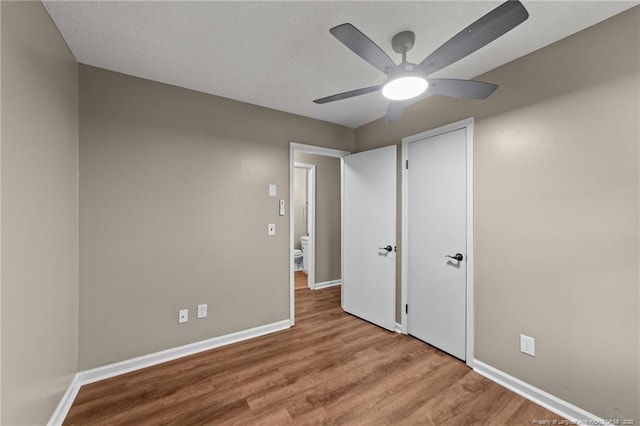 2308 Keith Dr, Raleigh, NC 27610 - unfurnished bedroom with wood finished floors, baseboards, ceiling fan, and a closet