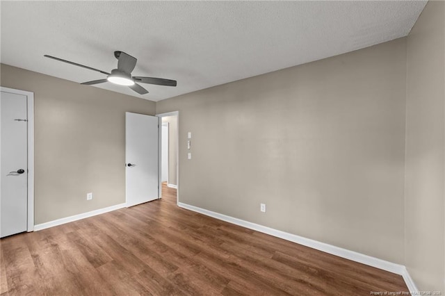 2308 Keith Dr, Raleigh, NC 27610 - unfurnished bedroom with wood finished floors, baseboards, ceiling fan, and a textured ceiling