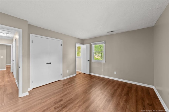2308 Keith Dr, Raleigh, NC 27610 - unfurnished bedroom with wood finished floors, baseboards, and a closet