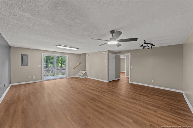 2308 Keith Dr, Raleigh, NC 27610 - empty room featuring wood finished floors, a textured ceiling, stairway, and baseboards