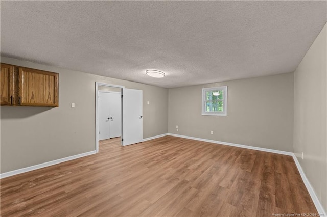 2308 Keith Dr, Raleigh, NC 27610 - unfurnished room featuring light wood-type flooring, baseboards, and a textured ceiling