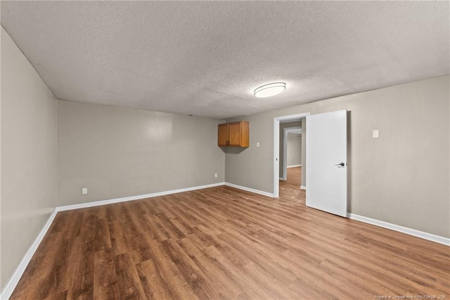 2308 Keith Dr, Raleigh, NC 27610 - unfurnished room with wood finished floors, baseboards, and a textured ceiling