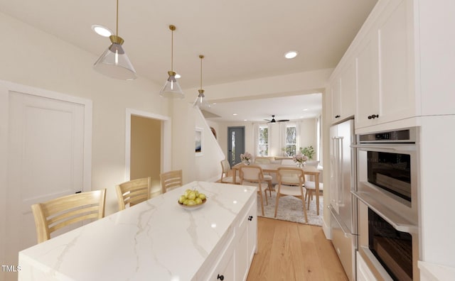 2940C Chapel Hill Rd, Durham, NC 27707 - kitchen featuring double oven, white cabinetry, light wood finished floors, recessed lighting, and pendant lighting
