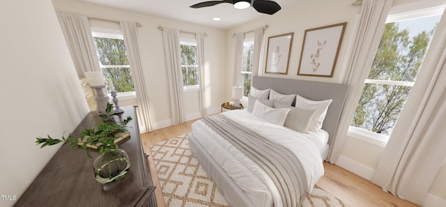 2940C Chapel Hill Rd, Durham, NC 27707 - bedroom with light wood finished floors, multiple windows, baseboards, and a ceiling fan