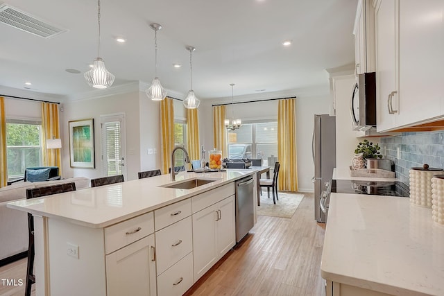 128 Bruce Dr, Dunn, NC 28334 - kitchen featuring stainless steel appliances, a sink, white cabinetry, a kitchen island with sink, and recessed lighting