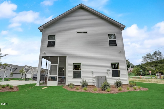 128 Bruce Dr, Dunn, NC 28334 - back of property featuring a yard, a sunroom, and central AC unit