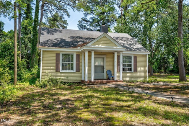940 Hill St, Rocky Mount, NC 27801 - bungalow-style home featuring a chimney, a front lawn, and a shingled roof