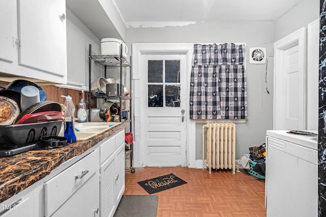 940 Hill St, Rocky Mount, NC 27801 - kitchen with radiator, white cabinets, and dark countertops