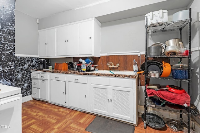 940 Hill St, Rocky Mount, NC 27801 - kitchen featuring stove, white cabinets, and dark stone countertops