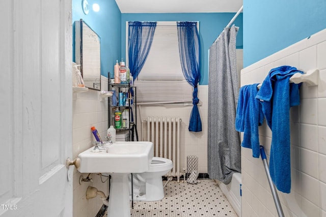 940 Hill St, Rocky Mount, NC 27801 - bathroom with radiator, tile walls, toilet, a shower with shower curtain, and wainscoting