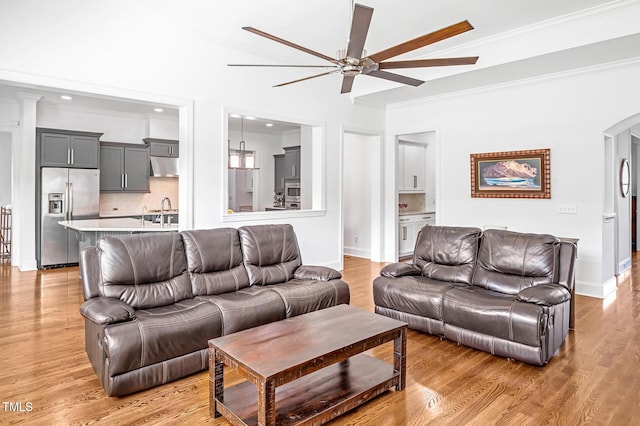 6250 Moinear Ln, Chapel Hill, NC 27514 - living room featuring a ceiling fan, crown molding, arched walkways, light wood-style flooring, and baseboards