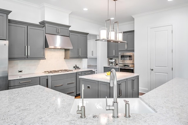 6250 Moinear Ln, Chapel Hill, NC 27514 - kitchen with appliances with stainless steel finishes, under cabinet range hood, gray cabinets, ornamental molding, and tasteful backsplash