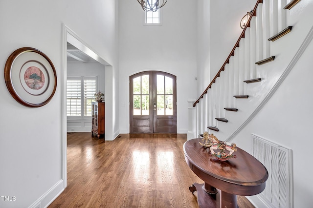 6250 Moinear Ln, Chapel Hill, NC 27514 - entrance foyer with wood finished floors, stairs, a high ceiling, baseboards, and french doors