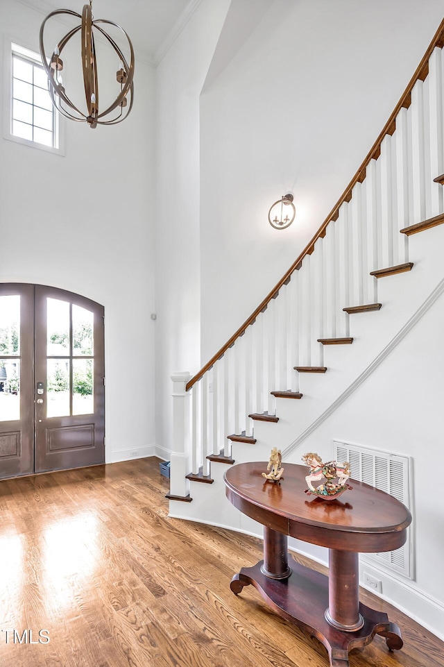 6250 Moinear Ln, Chapel Hill, NC 27514 - foyer with stairway, a towering ceiling, plenty of natural light, a chandelier, and wood finished floors
