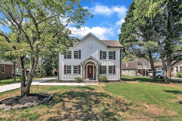 305 W Canary St, Dunn, NC 28334 - view of front facade with board and batten siding and a front lawn