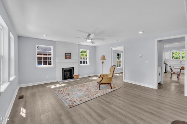 305 W Canary St, Dunn, NC 28334 - living area featuring light wood-style floors, ceiling fan, a large fireplace, baseboards, and recessed lighting