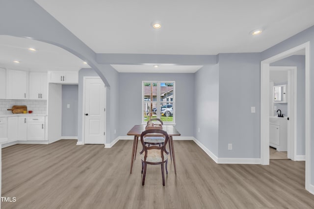 305 W Canary St, Dunn, NC 28334 - dining room featuring arched walkways, light wood finished floors, recessed lighting, and baseboards