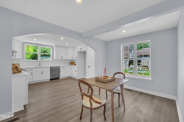 305 W Canary St, Dunn, NC 28334 - dining area featuring arched walkways, light wood-type flooring, baseboards, and recessed lighting
