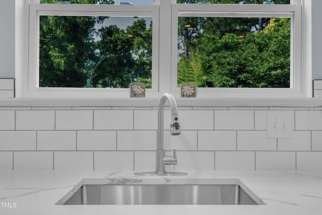 305 W Canary St, Dunn, NC 28334 - kitchen view of a sink, decorative backsplash, and light stone countertops