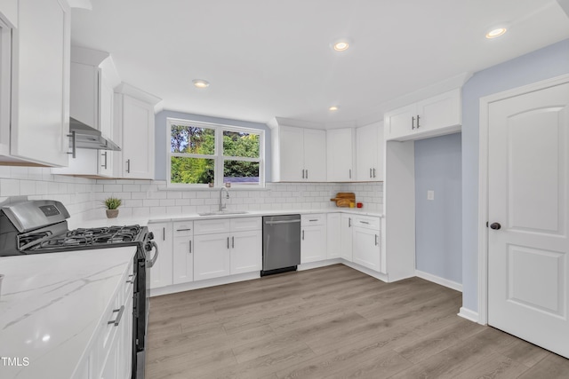 305 W Canary St, Dunn, NC 28334 - kitchen featuring stainless steel appliances, a sink, white cabinets, tasteful backsplash, and recessed lighting