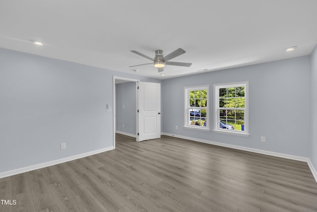 305 W Canary St, Dunn, NC 28334 - unfurnished room with a ceiling fan, baseboards, wood finished floors, and recessed lighting