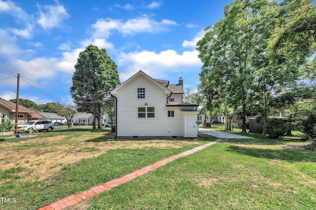305 W Canary St, Dunn, NC 28334 - back of house featuring crawl space, a chimney, and a yard
