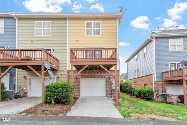 229 Michigan Ave, Cary, NC 27519 - rear view of house featuring a garage, concrete driveway, brick siding, and central AC unit