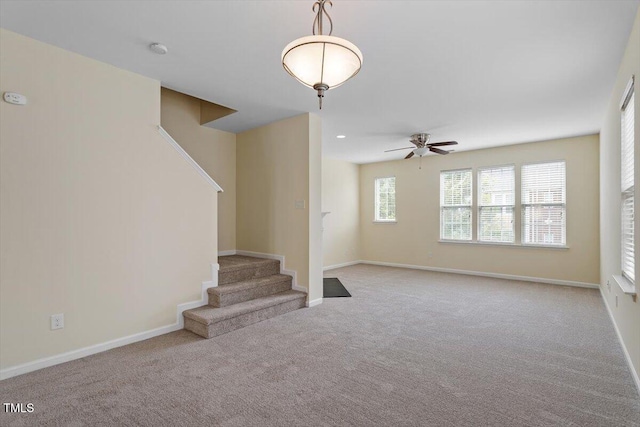 229 Michigan Ave, Cary, NC 27519 - unfurnished living room featuring stairway, carpet, ceiling fan, and baseboards