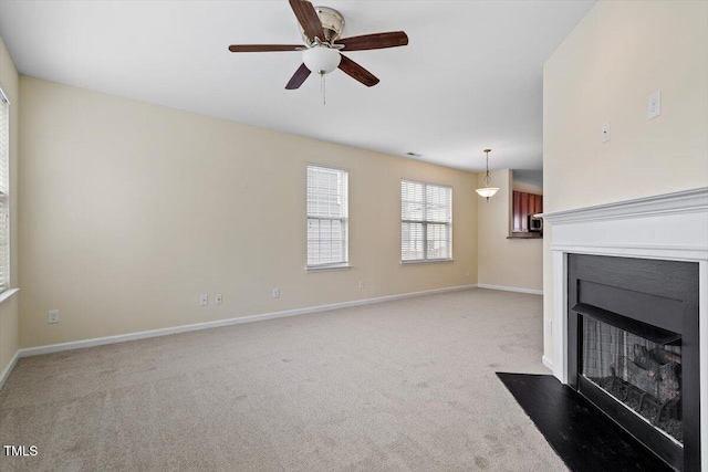 229 Michigan Ave, Cary, NC 27519 - unfurnished living room featuring a fireplace with flush hearth, light carpet, ceiling fan, and baseboards