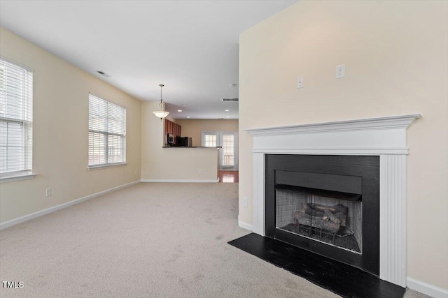 229 Michigan Ave, Cary, NC 27519 - unfurnished living room with a fireplace, baseboards, and light carpet